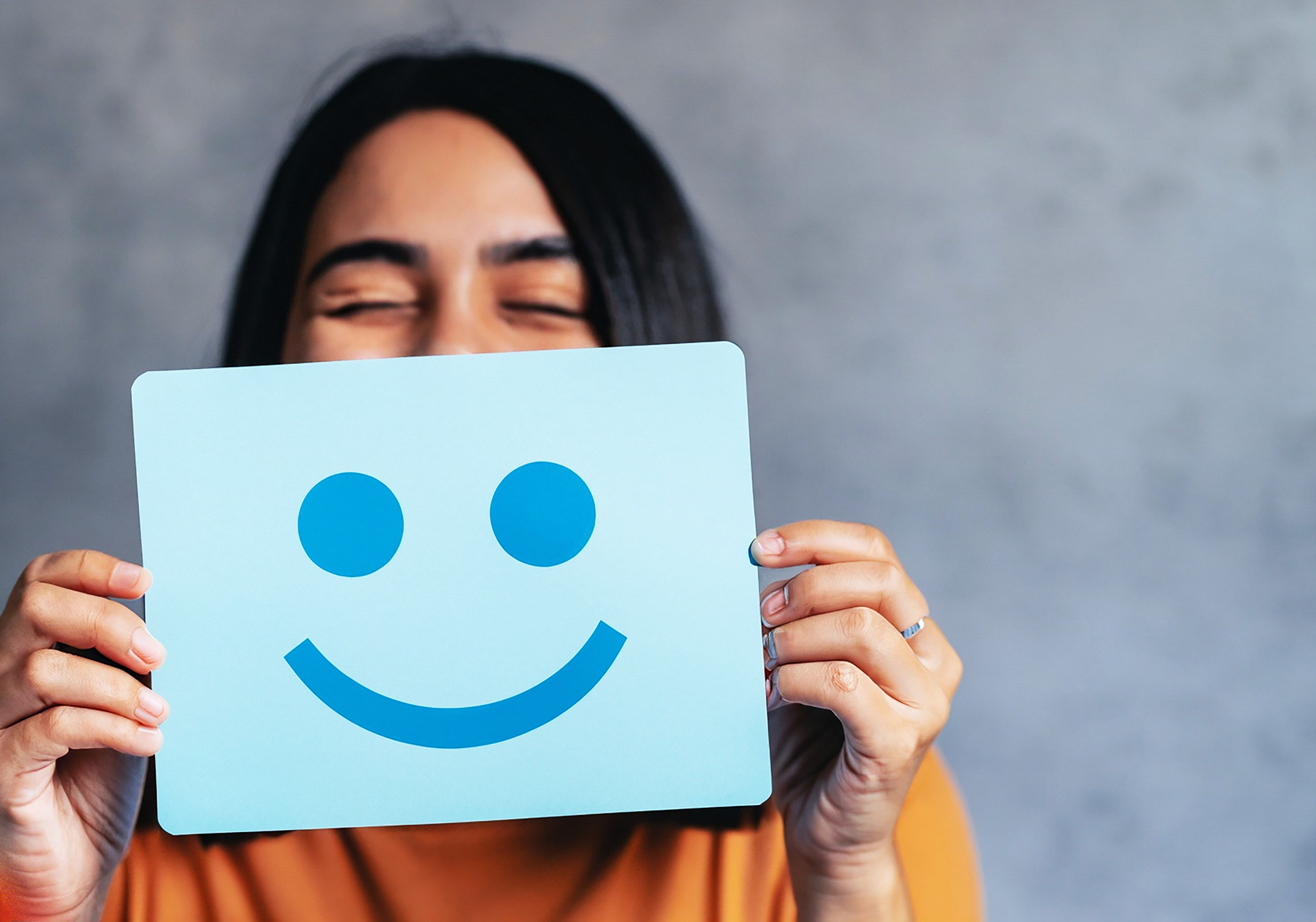 A person smiling, representing wellbeing and recovery